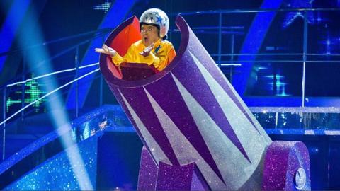 Russell Grant playing a human cannonball