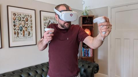 John Bevan enjoys rock climbing in virtual reality using a headset gifted by his employer