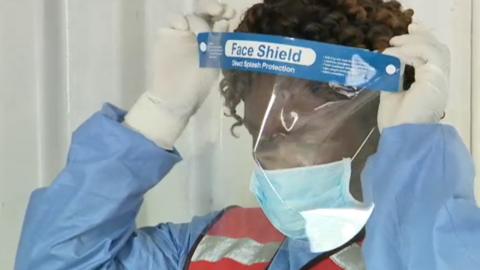 Red Cross worker in protective clothing