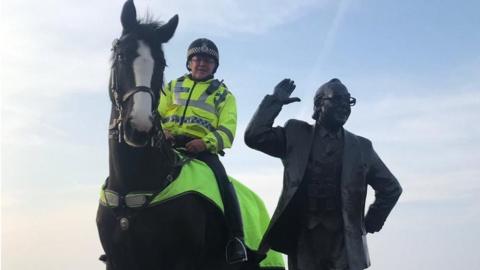 Morecambe police horse with Eric Morecambe statue