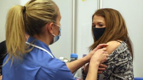 Woman receiving a vaccine