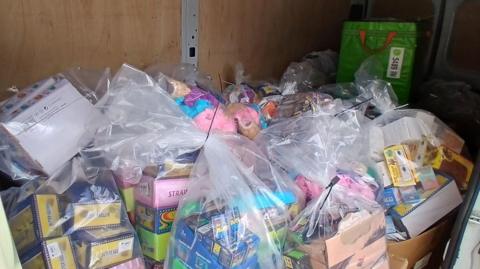 Dozens of toys - many boxed - wrapped up in clear plastic bags.