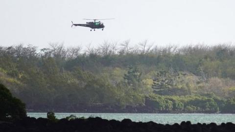 Search and rescue helicopter flies over the site of the collision off Mauritius on 31 August 2020