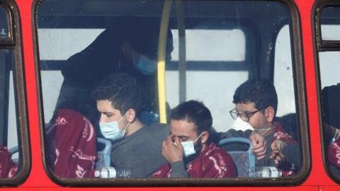 people sitting on red bus