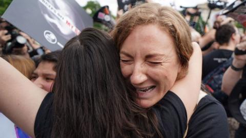 Pro-life activists hug outside the US Supreme Court in Washington, DC