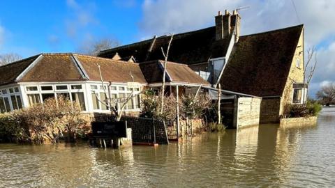 Flood water surrounding The Pike & Eel Hotel and Marina