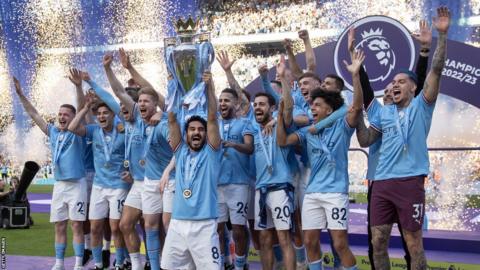 Ilkay Gundogan lifts the Premier League trophy, surrounded by team-mates, as Manchester City celebrate winning the 2022-23 title