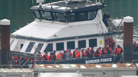 Alleged asylum seekers arrive in the UK on a Border Force boat