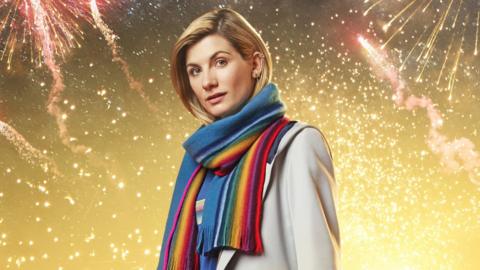 Jodie Whittaker wearing a multi-coloured scarf, as the Doctor.