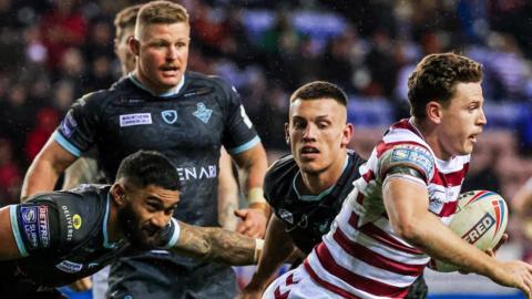 Wigan and Huddersfield in action against each other in February