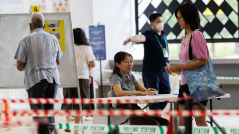 Citizens register to vote at a polling station for the presidential election in Singapore