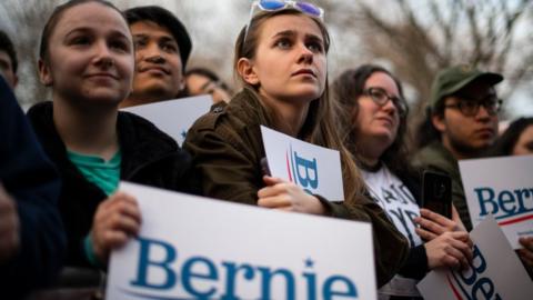 Supporters look on as Rep. Alexandria Ocasio-Cortez (D-NY) speaks during a campaign rally for Democratic presidential candidate Sen. Bernie Sanders on 8 March, 2020 in Ann Arbor, Michigan