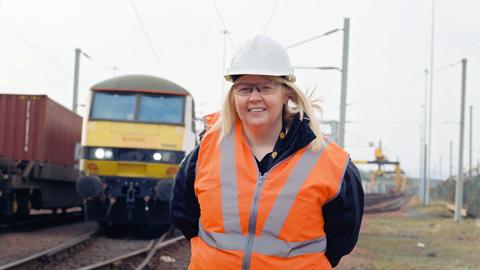 Heather Waugh, stands in front a Class 90 locomotive, at the start of her shift