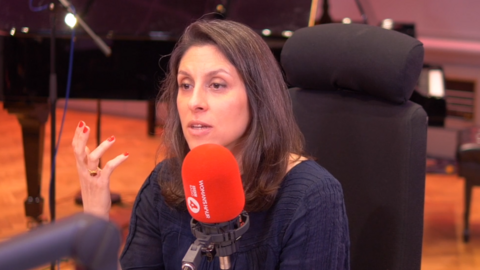 Nazanin Zaghari-Ratcliffe speaking on Woman's Hour in front of a red microphone