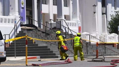 Fire fighters enter the fire damaged entrance to Old Parliament House are seen in Canberra, Australia, 30 December 2021.