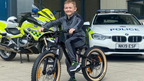 Noah sits on the bike