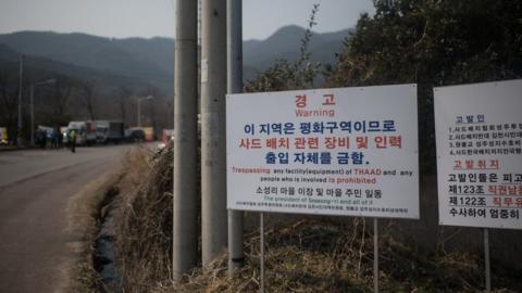 A sign is displayed outside a golf course being used as the site for the recently installed US Terminal High Altitude Area Defense (THAAD) system, in Seongju on March 18, 2017.