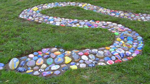 Close up of the painted stones that make up the Towcester Rock Snake