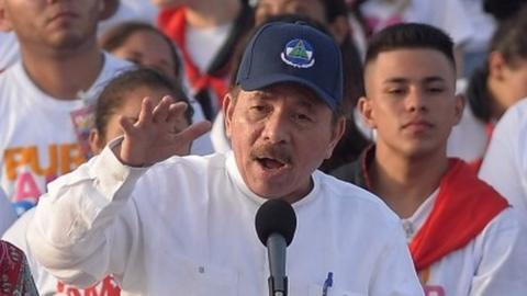 Nicaraguan President Daniel Ortega (R) delivers a speech next to his wife and Vice President Rosario Murillo during the commemoration of the 39th Anniversary of the Sandinista Revolution at "La Fe" square in Managua on July 19, 2018.