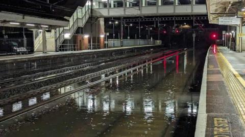 Flooded tracks at a train station