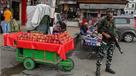 A security personnel stands guard amid escalating violence