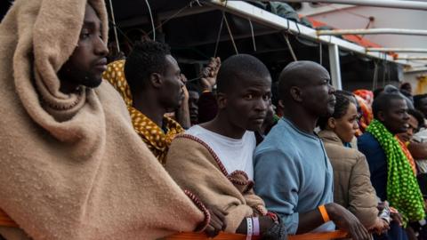 Refugees and migrants wait on deck of the Spanish NGO Proactiva Open Arms rescue vessel Golfo Azzurro to disembark after being rescued off Libyan coast north of Sabratha, Libya on February 19, 2017