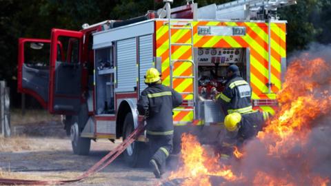 Firefighters putting out a blaze