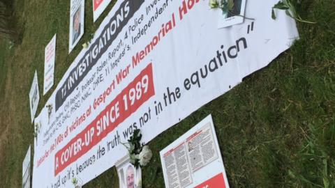 Family tributes and protest banners outside Portsmouth Cathedral