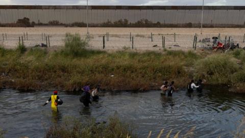 A group of migrants crossing into the US on 8 November 2023