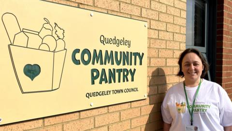 Councillor Vicky Ranford stood by the sign on the front of Quedgeley Community Pantry