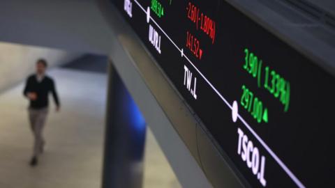 A man walks down a corridor at the London Stock Exchange