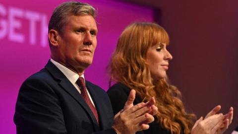 Keir Starmer and Angela Rayner clap on stage during the opening day of the annual Labour Party conference in Brighton, on 25 September 2021