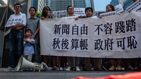 Demonstrators hold a banner that reads "freedom of the press, not allowed to be trampled" out7