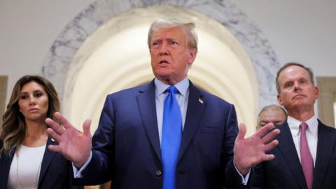 Former President Donald Trump speaks to reporters outside court