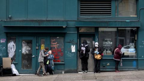 Clients wait outside of Insite, a supervised consumption site located in the Downtown Eastside (DTES) neighborhood, has injection booths where clients inject pre-obtained illicit drugs under the supervision of nurses and health care staff.