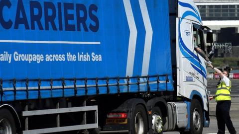 A port worker checks the paperwork of a lorry at the port of Larne in Northern Ireland