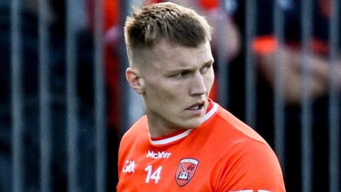 Rian O'Neill walks off at Healy Park after his first-half red card