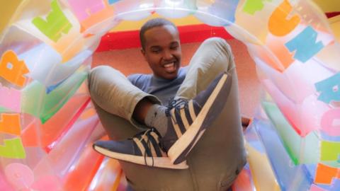 Young person playing inside an inflatable ring