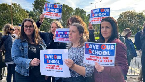 Parents holding placards outside St Leonards school in Durham in September 2023