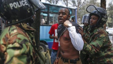 A Kenyan activist Boniface Mwangi protests against police officers as he shows his chest wounded by a tear gas canister during a demonstration against recent police brutality that killed some opposition protesters, in Nairobi, Kenya, 19 October 2017