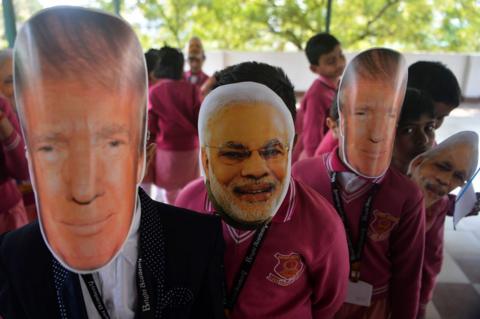 People wearing Trump and Modi masks in India