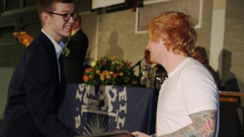 Tom Turner being presented with his award by Ed Sheeran