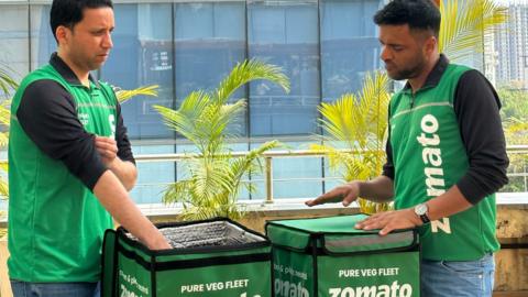 Zomato's delivery riders in green uniform with green delivery boxes
