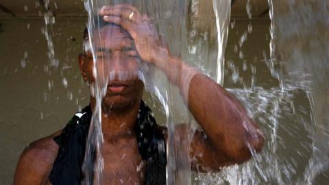 A man cools off at Madureira Park in the northern zone of Rio de Janeiro, Brazil, on 18 November 2023