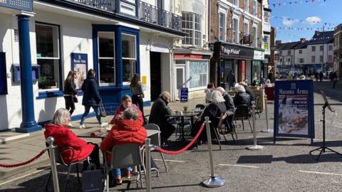 People sitting outside hotel