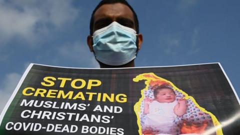 A Sri Lankan Muslim holds a placard as he demonstrates near the office of President Gotabaya Rajapaksa, in Colombo on December 16, 2020.