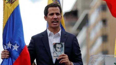 Juan Guaido, President of Venezuela"s National Assembly, holds a copy of Venezuelan constitution during a rally against Venezuelan President Nicolas Maduro"s government and to commemorate the 61st anniversary of the end of the dictatorship of Marcos Perez Jimenez in Caracas, Venezuela January 23, 2019.