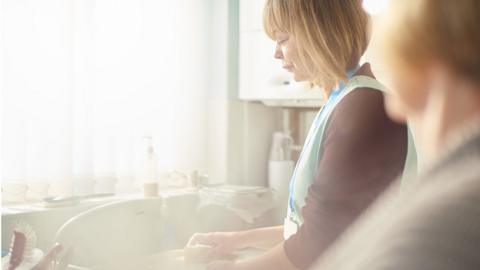 Care worker at sink