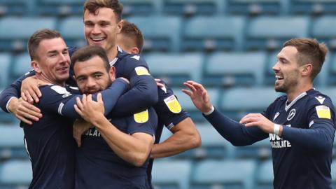 Millwall players celebrate scoring a goal against Brentford