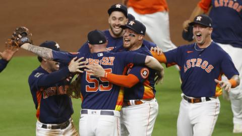 Houston Astros players engulf pitcher Ryan Pressly after they win the World Series